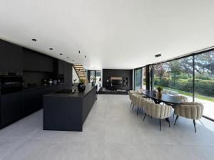 a kitchen and dining room with a table and chairs at Maison Unifamiliale in Theux