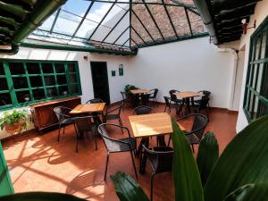 an empty patio with tables and chairs in a building at Hotel Altair in Villa de Leyva
