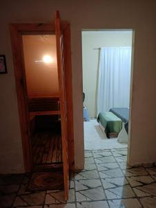 a room with a door open to a bedroom at SPA Alexandre Maia quarto 1 in Juazeiro do Norte