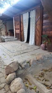 an outside entrance to a house with wooden doors at SPA Alexandre Maia quarto 1 in Juazeiro do Norte