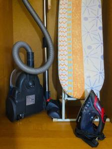 a vacuum cleaner sitting on top of a wooden floor at Comfort Home Gogolya in Karagandy