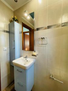 a bathroom with a sink and a mirror at The Greek Mama's Cottage in Epanomi +27 photos