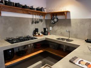 a kitchen with a stove and a sink at Casa bambu atins in Atins