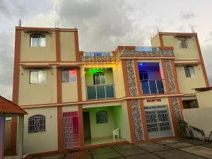 a building with colorful doors and windows at Darlouis hotel cap Haitien in Au Bery