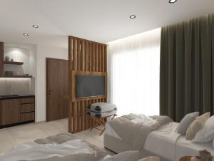a bedroom with a tv and a bed and a room at Azulic Suites Nikiti in Nikiti