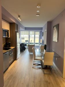 a kitchen and dining room with a table and chairs at Downtown Luxury Condo Gym & Parking in Toronto