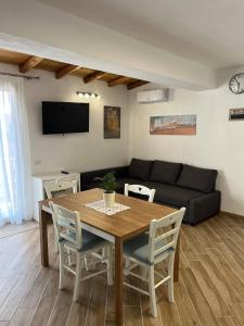 a living room with a table and a couch at Apartment, Sulina's House 2 in Campofelice di Roccella