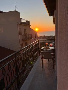 a view of a balcony with a table and a sunset at Apartment, Sulina's House 2 in Campofelice di Roccella