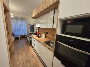 a kitchen with a sink and a microwave at Ski & SunDeck in Bjelašnica