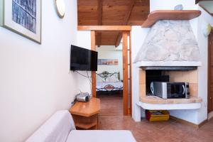 a living room with a fireplace and a tv at Apartments Vrtina in Igrane