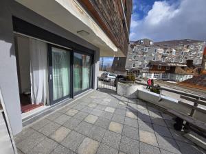 a balcony with a view of a building at Ski & SunDeck in Bjelašnica