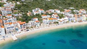 an aerial view of a beach with buildings and the water at Apartments Vrtina in Igrane