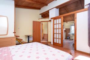 a bedroom with a bed in a room with wooden ceilings at Apartments Vrtina in Igrane