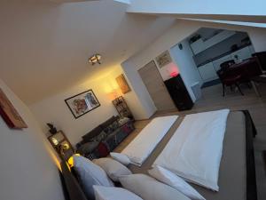 a view of a living room with a couch at Bright studio-flat near station - Bayreuth in Bayreuth +13 photos