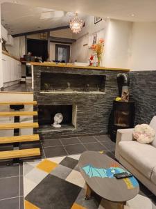 a living room with a couch and a fireplace at LE PANORAMIC- Sainte Agnès in Sainte-Agnès