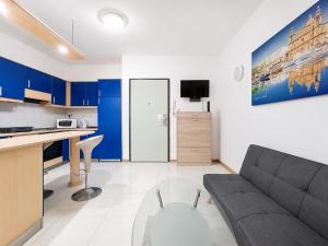 a living room with a couch and a table at Central Msida Modern Holiday Apartment in Tal-Ħriereb
