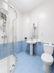 a bathroom with a toilet and a sink and a shower at Central Msida Modern Holiday Apartment in Tal-Ħriereb +9 photos