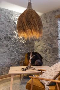a room with a table and a pendant light at Naturhaus Leger in Lenggries
