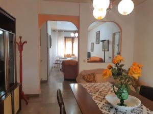 a living room with a vase of flowers on a table at Caterina in Marina di Massa