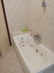 a white bath tub in a bathroom at Caterina in Marina di Massa