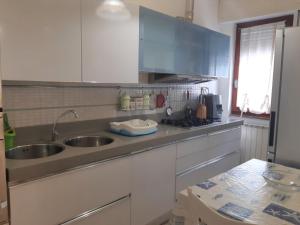 a kitchen with a sink and a counter top at Caterina in Marina di Massa +4 photos