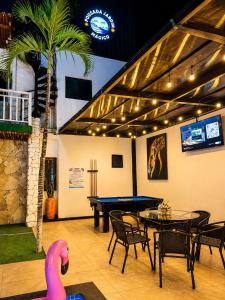 a ping pong room with a ping pong table and a ping pong at Pousada Jardim Mágico in Ponta Negra