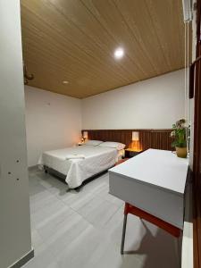 a bedroom with a bed and a table in it at La Casona in Arauca