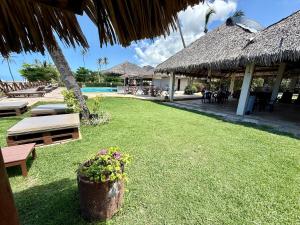 a resort with a yard with benches and a pool at ECO PARADISE -Apt 212 in Caucaia