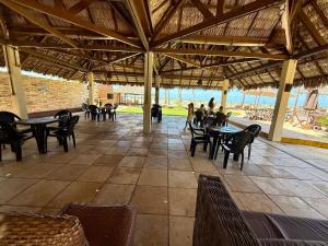 a patio with tables and chairs and people sitting at ECO PARADISE -Apt 212 in Caucaia