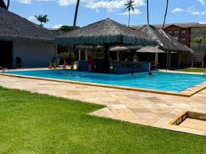 a swimming pool in a resort with people in it at ECO PARADISE -Apt 212 in Caucaia