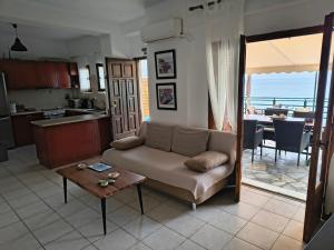 a living room with a couch and a table at Kamari Guesthouse in Keramídhion