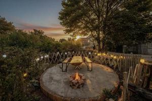 a backyard with a fire pit and a table and chairs at Bear house Dalat in Da Thien