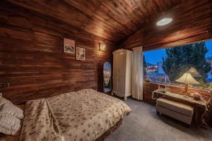 a bedroom with a bed and a large window at Bear house Dalat in Da Thien