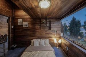 a bedroom with a bed and a large window at Bear house Dalat in Da Thien +12 photos