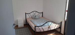 a small bedroom with a bed with a metal frame at FIRMENWOHNUNG Monteurunterkunft in Weng
