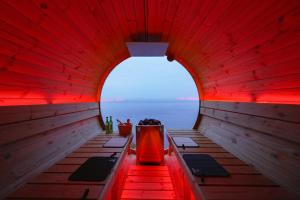 a boat with a red ceiling and a view of the ocean at 河津Blue Ocean in Kawazu