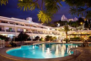 a pool in front of a hotel at night at HOVIMA Panorama in Adeje