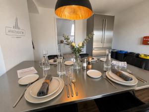 a table with white plates and utensils on it at apartment11 in Ulm