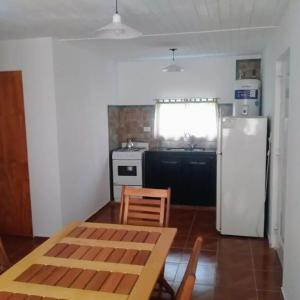a kitchen with a refrigerator and a table and chairs at Los 3 Gurises in Gualeguay