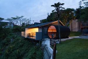 a house on a hill with a round window at 河津Blue Ocean in Kawazu +133 photos