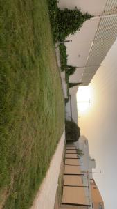 a row of stairs next to a grassy hill at شاليه in Al Bukayriyah +3 photos