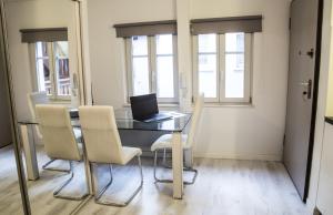 a dining room with a table with a laptop on it at Magnifique studio proche Cathédrale in Strasbourg