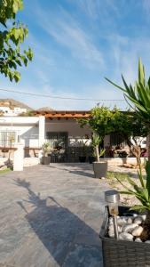 a patio with plants and a white building at Villa Karma in Berja