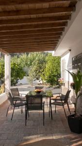 a patio with chairs and a table and a tableablish at Villa Karma in Berja