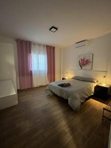 a bedroom with a large bed and a window at Villa Karma in Berja +56 photos