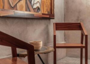 a wooden chair and a basket on a table at HOTEL ZAZIL KIN TULUM serenity & wellness in Tulum