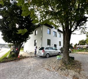 a silver car parked in front of a white house at Casa Stein am Rhein inkl Pool in Stein am Rhein
