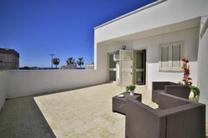 a white house with a patio and a balcony at Hotel da ettore in Porto Cesareo