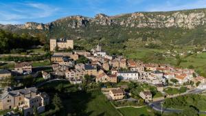 an aerial view of a village in the mountains at Gîte des pêcheurs, Gorges du Tarn in Mostuéjouls