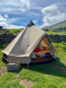 a tent in the middle of a field at Wild Camping Teepee in Capel Curig